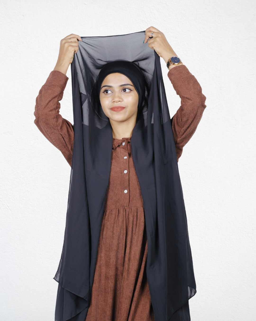 A woman wearing a black instant hijab, offering a sleek and effortless look.