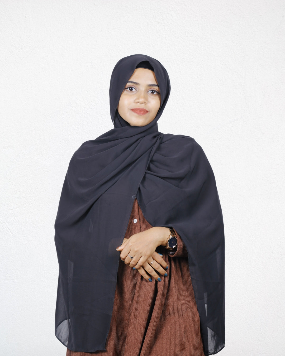 A woman showcasing a black instant hijab, combining comfort and style in one.