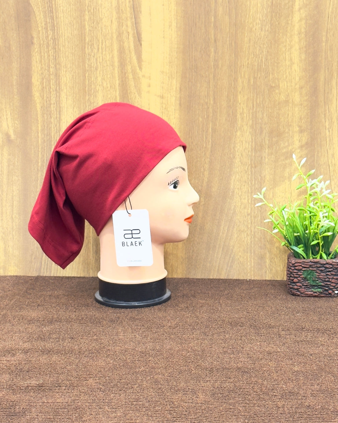 Cherry hijab tube cap showcased from the side.