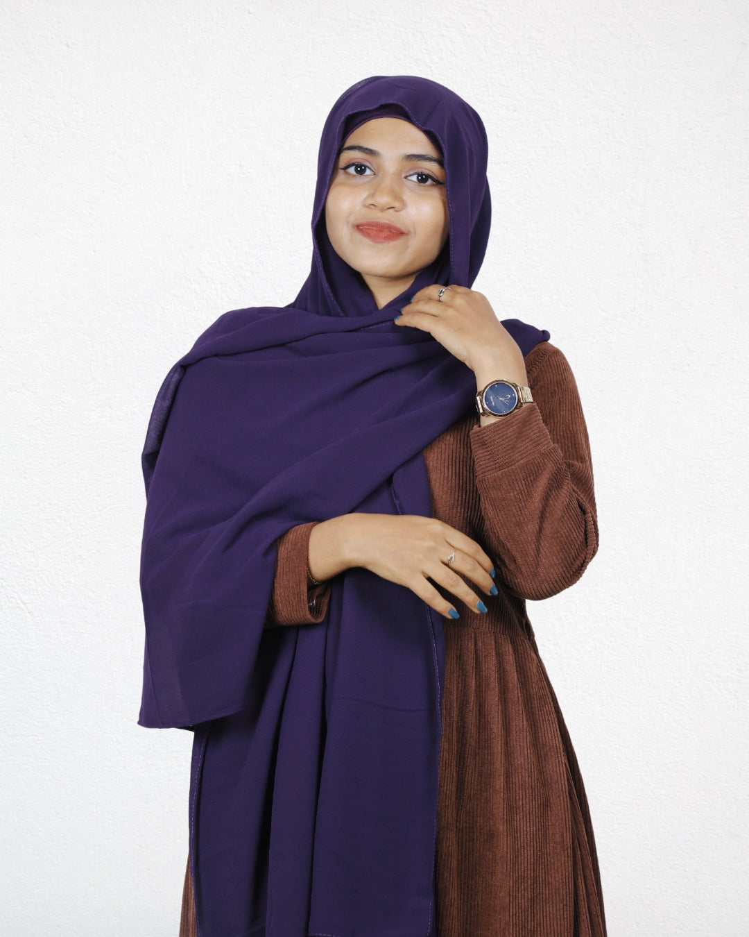 A woman showcasing an eggplant chiffon scarf, perfect for adding depth to her style.