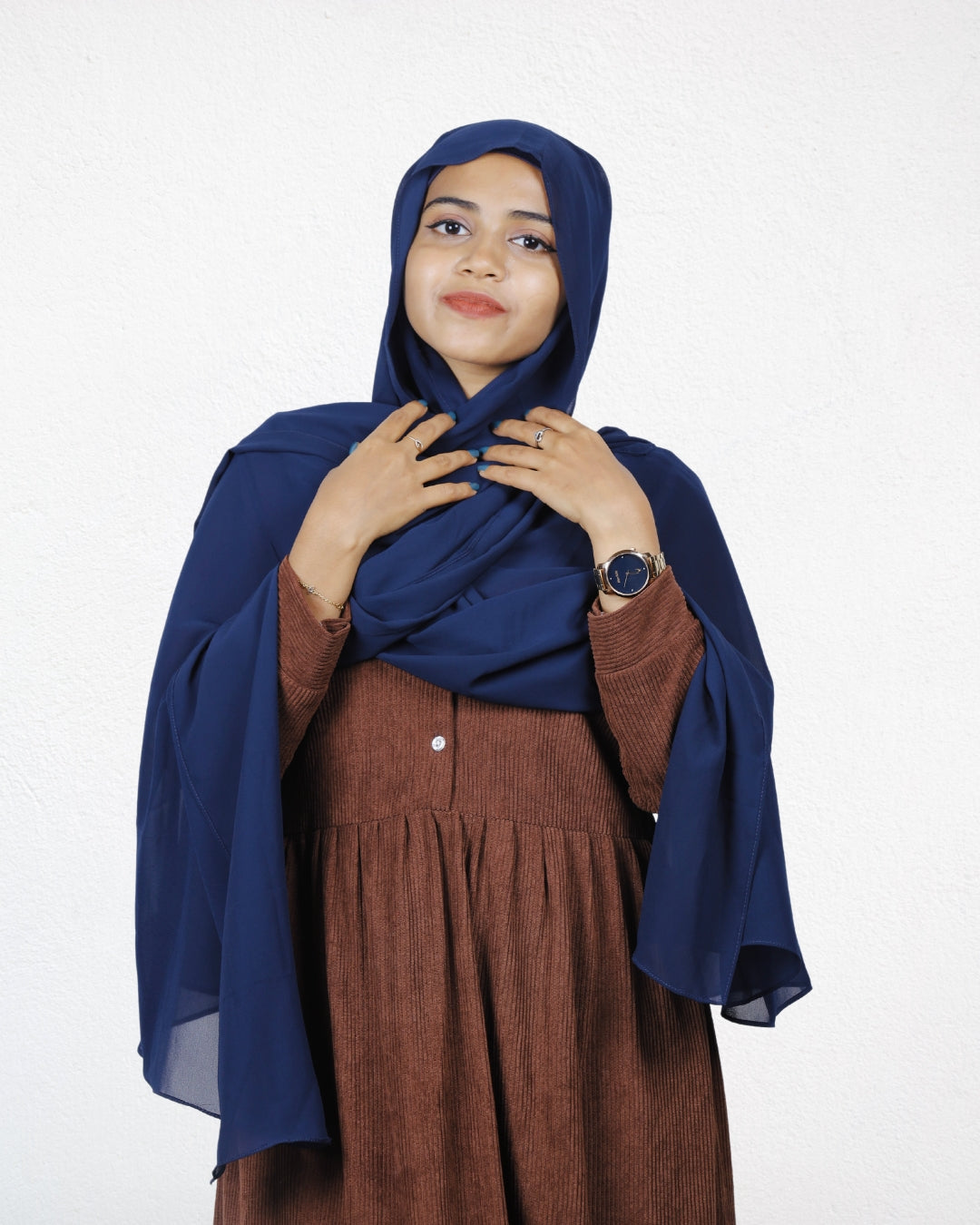 A woman wearing a navy blue chiffon scarf, adding a classic touch to her outfit.