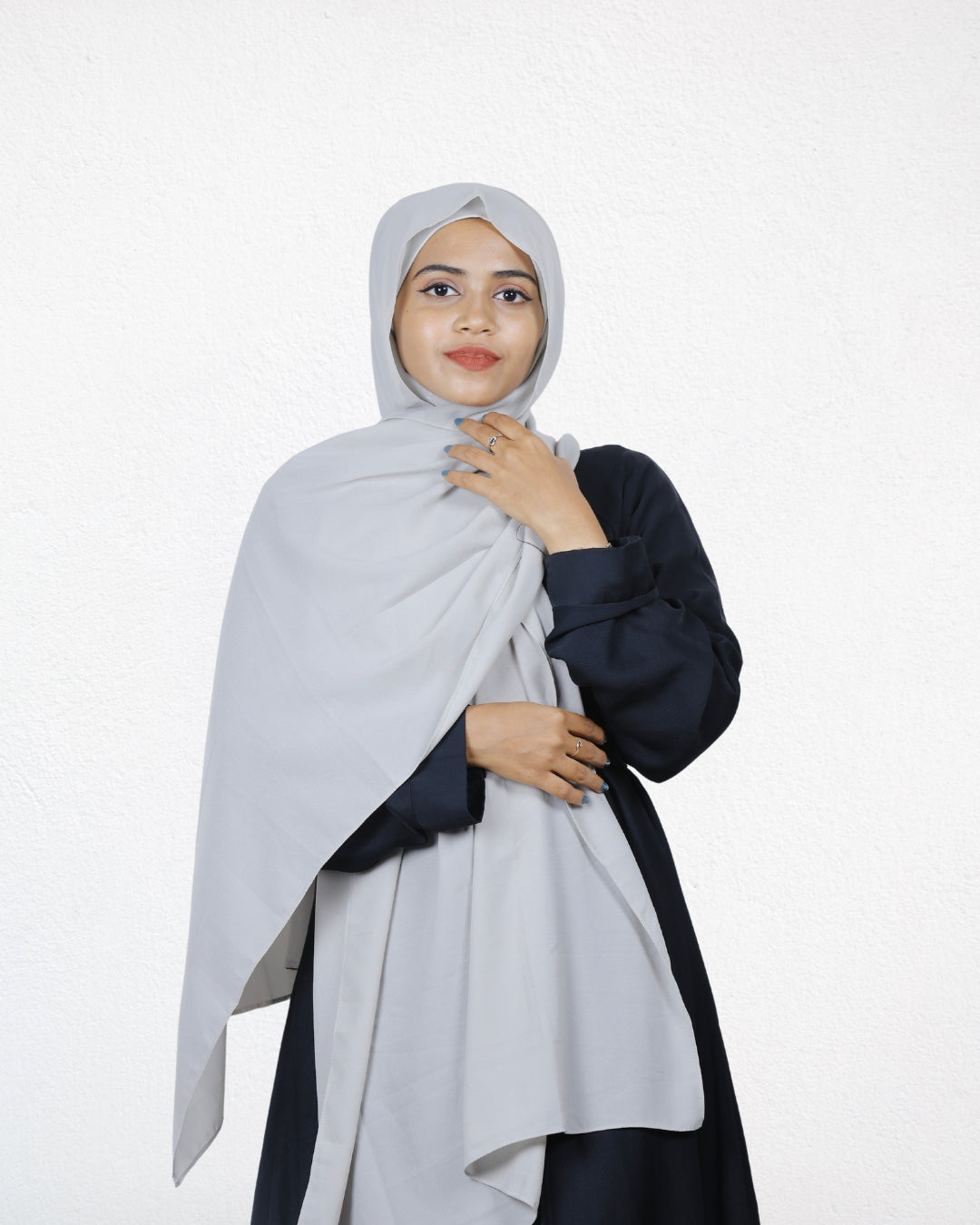 The silver instant hijab adds a touch of shine to her outfit.