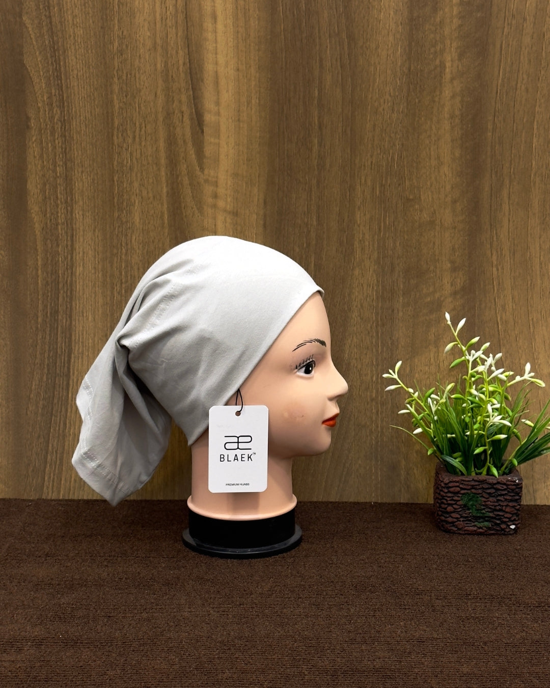 Silver hijab tube cap displayed in a side angle.