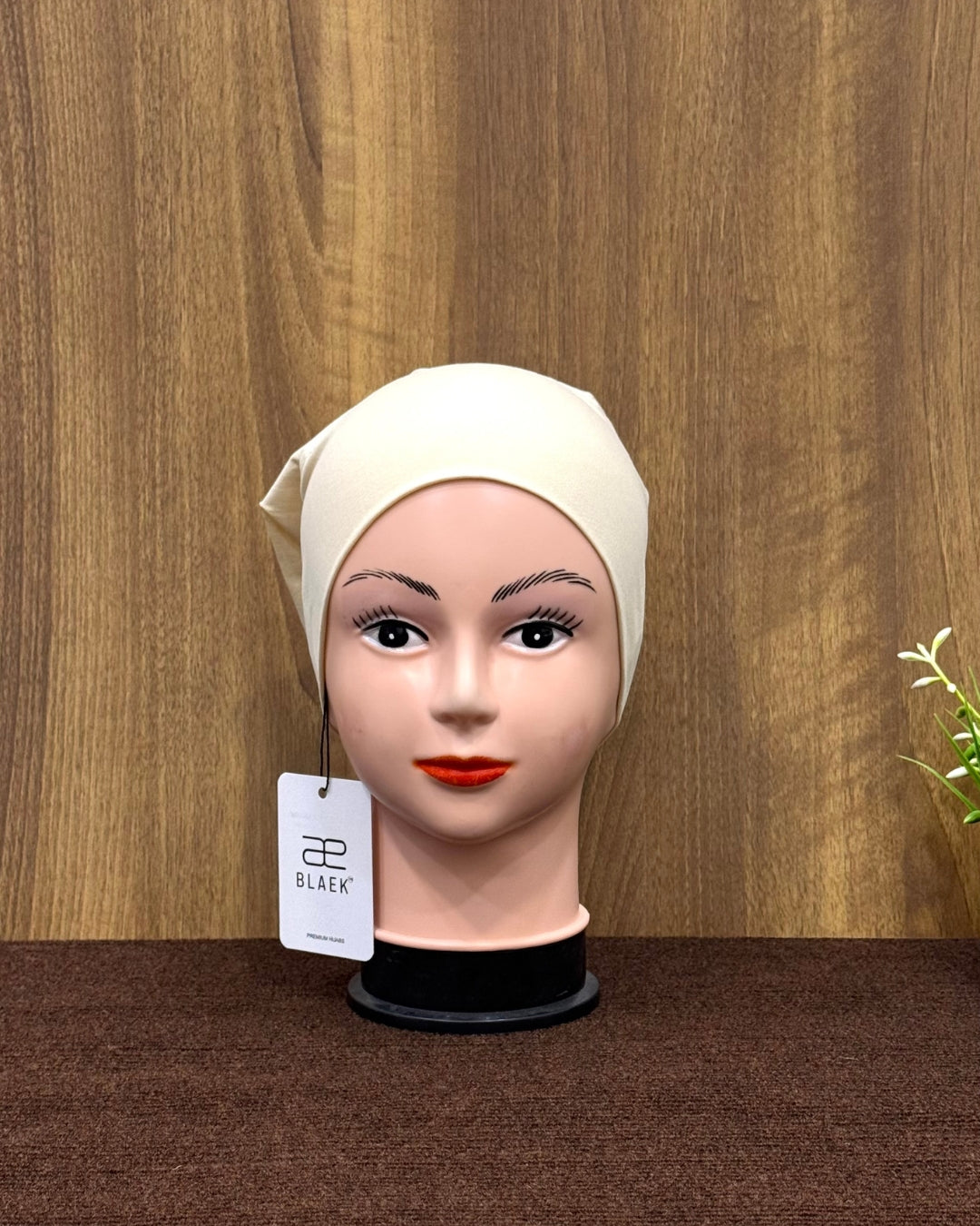 Front-facing vanilla hijab tube cap for display.